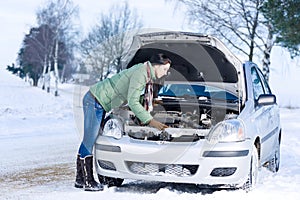 Winter car breakdown - woman repair motor