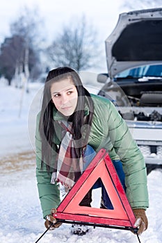 Winter car breakdown - woman warning triangle