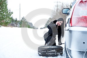 Winter car breakdown - young beautiful woman call for help, road