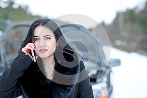 Winter car breakdown - young beautiful woman call for help, road