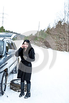 Winter car breakdown - young beautiful woman call for help, road