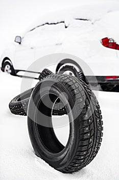 Winter car tire on snow at shallow depth of field