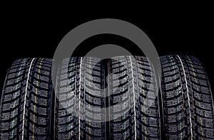 Winter car tires isolated on black background