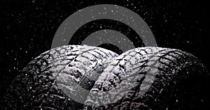 Winter Car tires with snow flakes on black background. Winter season. Slow motion 4k video