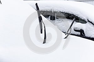 Winter car wipers. Car standing in snow.