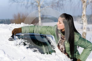Winter car - woman remove snow from windshield photo