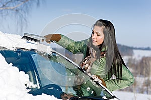 Winter car - woman remove snow from windshield