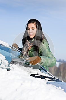 Winter car - woman remove snow from windshield