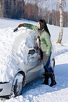 Winter car - woman remove snow from windshield