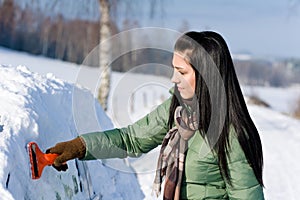 Winter car - woman remove snow from windshield