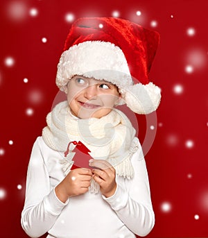 Winter, child, christmas concept - happy girl in santa hat show