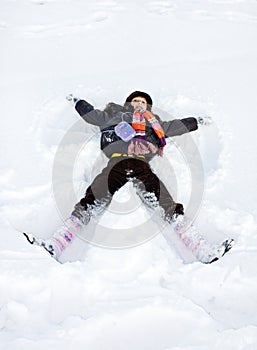 Winter child play lie in snow