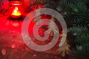 Winter Christmas Backgroun. Christmas Tree. Burning red candle. Snow Falling Effect. Dark image.