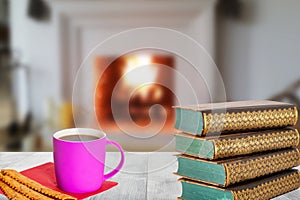 Winter christmas books background. A stack of antique books with a coffee mug and Italian pastries on a wooden table over abstract
