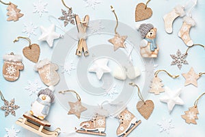 Winter Christmas composition with wooden decorations on a blue background. Flat lay top view