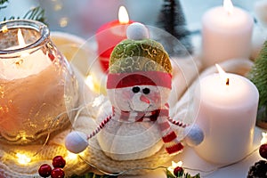 Winter Christmas holidays background with candles; christmas light; Cup of cocoa with marshmallow or hot chocolate near a window