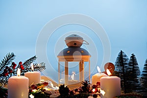 Winter Christmas holidays background with candles; christmas light; Cup of cocoa with marshmallow or hot chocolate near a window