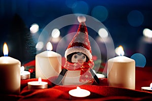 Winter Christmas holidays background with candles, christmas light, toy near a window