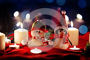 Winter Christmas holidays background with candles, christmas light, toy near a window