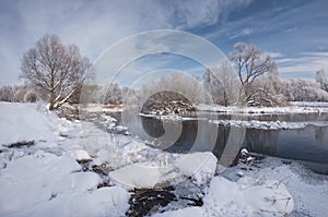 Winter Christmas Landscape In Blue Tones With Calm River, Surrounded By Trees. Landscape With Snowy Trees, Beautiful Frozen River