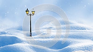 Winter Christmas new year card. Lonely lantern on the background of snow drifts of snowfall. Copy space. Winter wonderland.