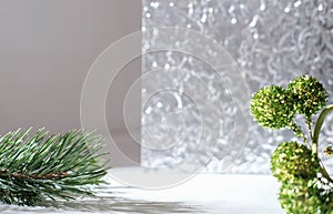 Winter Christmas scene with pine twigs for product presentation cosmetics. advertising display with textured acrilic