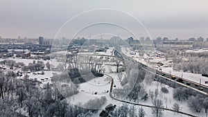 Winter city garden.  Trees in the snow. Flying over a snow-covered park. Aerial photography