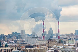 Winter city landscape. Steam from the pipes to heat the building