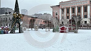 Winter city in Ukraine and Christmas festive decorated square during snowfall