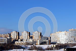 Winter cityscape with houses on a sunny frosty day.