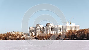 Winter Cityscape with modern buildings or houses and blue sky in sunny day