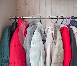 Winter clothes in a closet on a coat hanger. cleaning winter clothes until next season