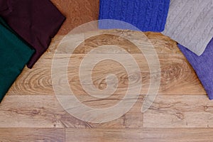 Winter clothes collection on wooden background