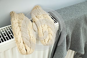 Winter clothes drying on radiator, close up