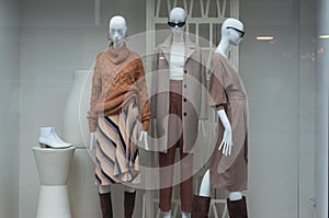 winter clothes on mannequins in a women fashion store showroom