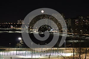 winter cloudless night view of the city - full moon over high-rise buildings