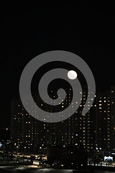 winter cloudless night view of the city - full moon over high-rise buildings