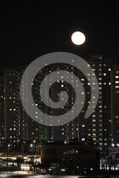 winter cloudless night view of the city - full moon over high-rise buildings