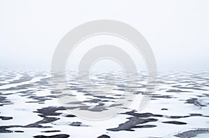 Winter coastal landscape with ice and snow at daytime.