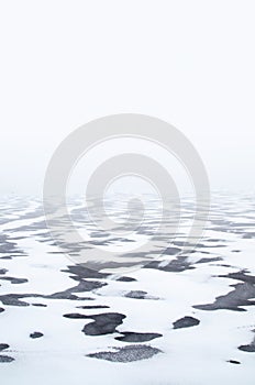 Winter coastal landscape with ice and snow at daytime.