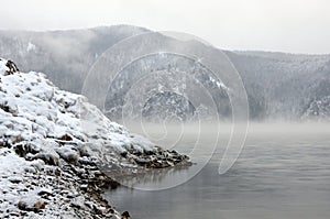 Winter cold foggy dawn on the Yenisei river