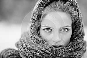 Young and blond girl wearing blue scarf in winter