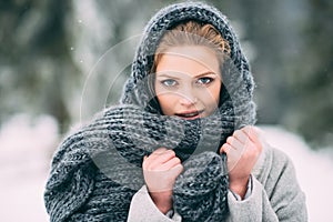 Young and blond girl wearing blue scarf in winter