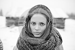 Young and blond girl wearing blue scarf in winter