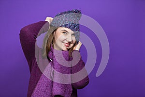 Winter Concepts. Positive Funny Caucasian Adult Female Woman In Warm Knitted Hat and Violet Scarf Posing with Lifted Hands And