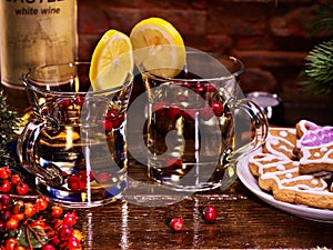 Winter cookies plate and two glasses mug with red berries.