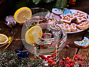 Winter cookies plate and two punch glasses mug with berries.