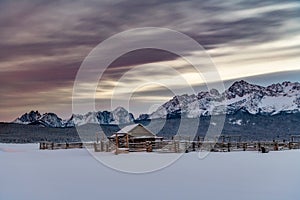 Winter corral and cabin with Sawtooth Mountains backdrop