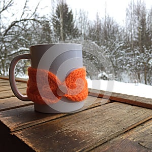 Winter cosiness: white ceramic mug of tea or coffee