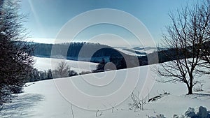 Snow blanket over the hills in a countryside in winter